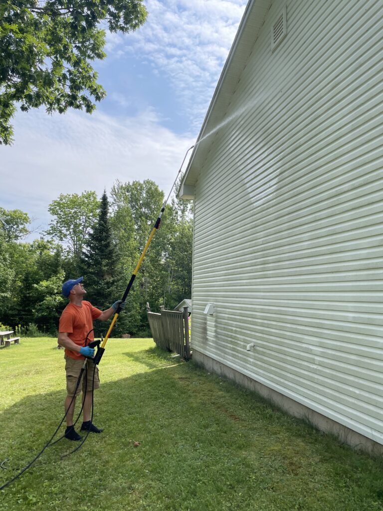 Pressure washing a home exterior in Moncton